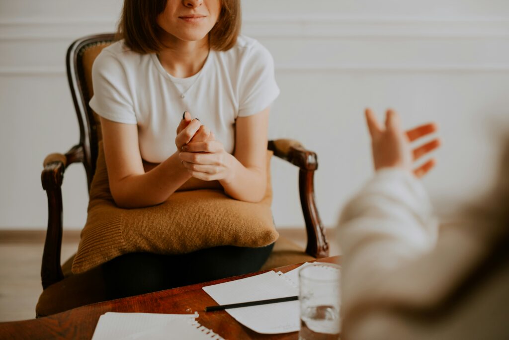 A woman is calmer as she works through her grief around losing a pet with a counselor at Awakened Path.