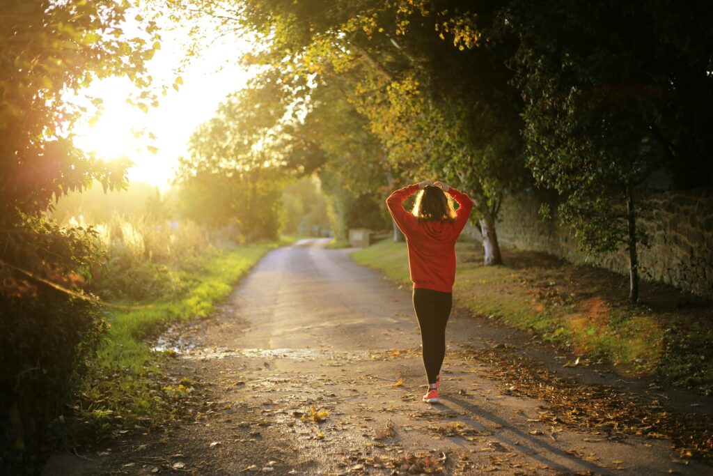 woman walking in nature to decrease stress