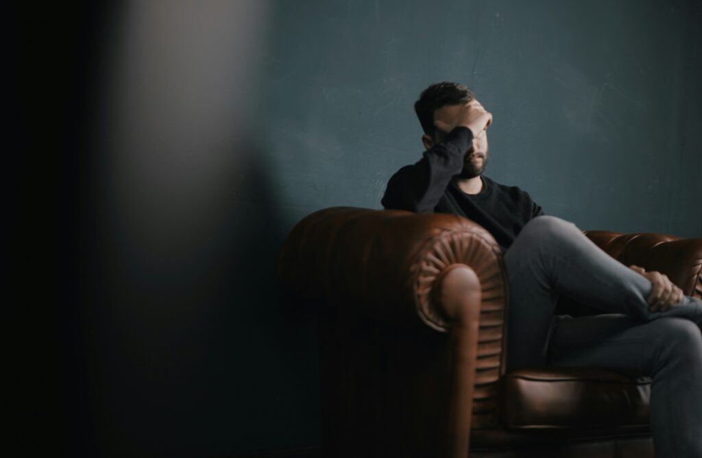 man sits in therapy after waiting to begin therapy until after crisis