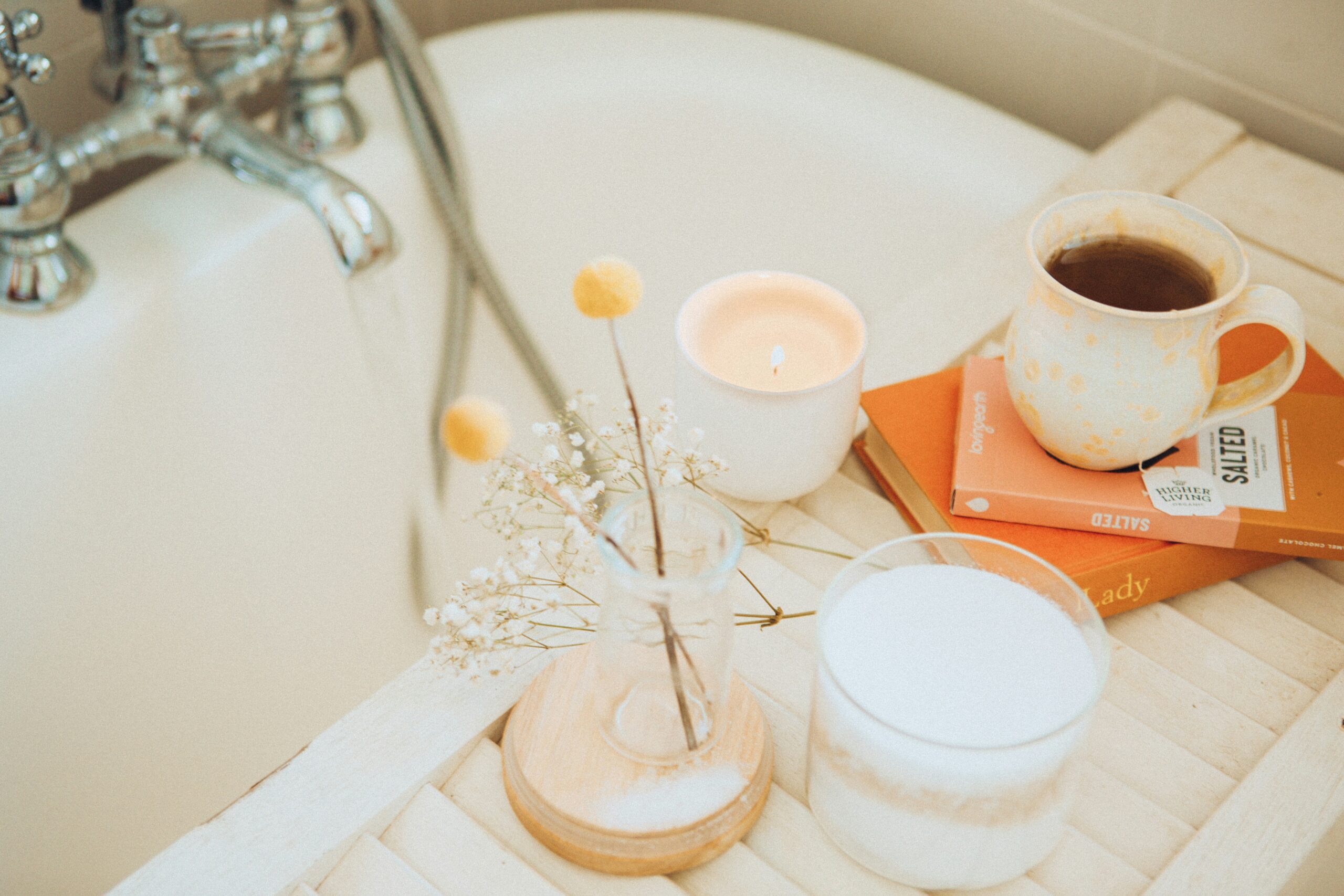 coffee and flower vase near a bathtub