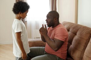 an African American father talking to his young son trying to tap into mindful parenting