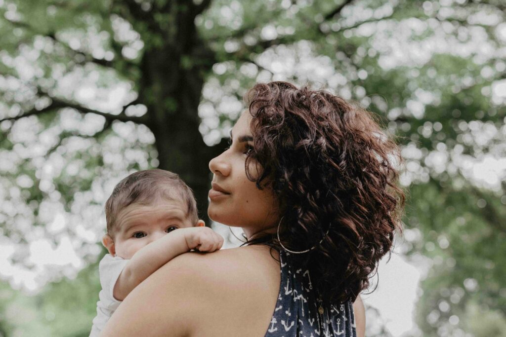 a mother in postpartum recovery holding her baby