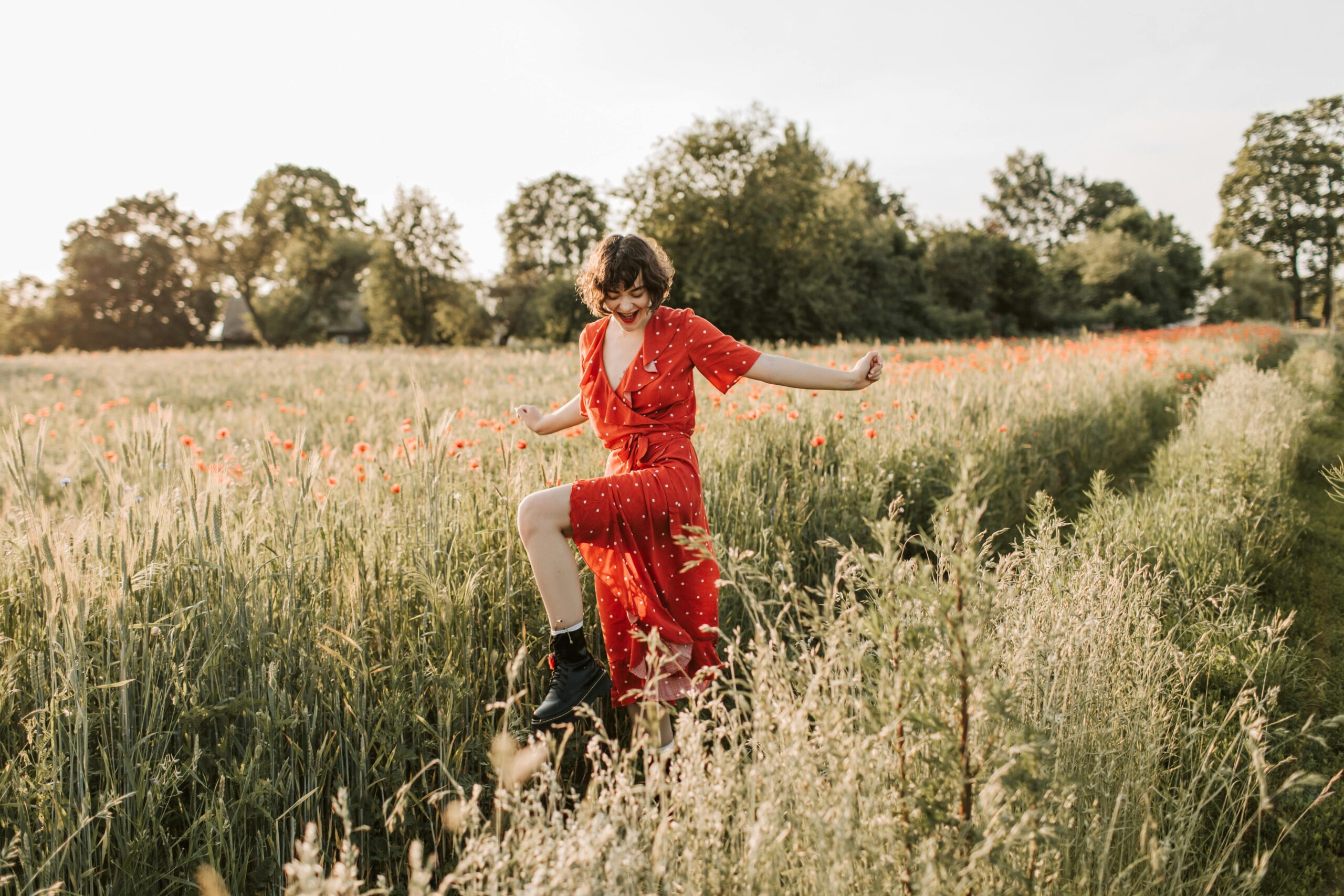 woman happy in a field after healing from trauma